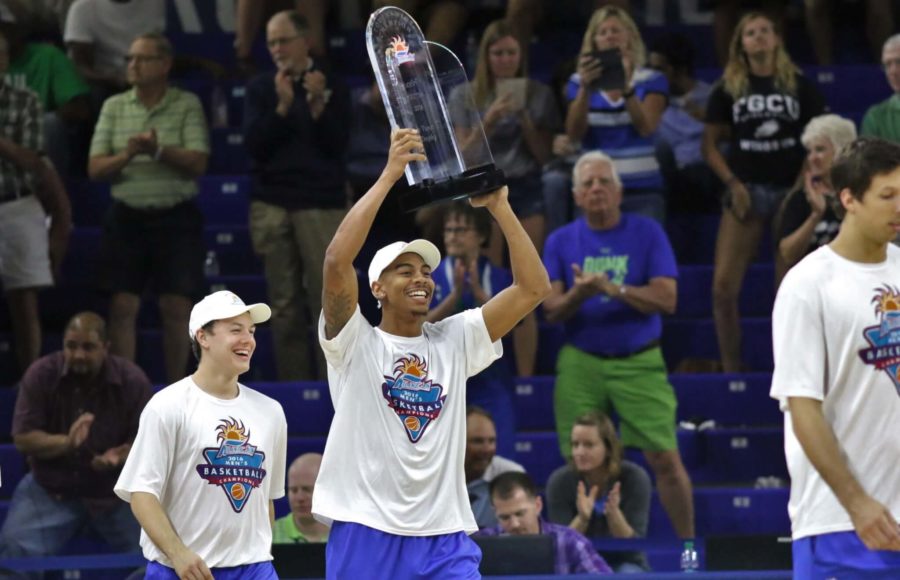 FGCU senior Julian DeBose lifts the Atlantic Sun Conference Championship trophy during halftime of the womens semifinal game when the team was honored on Wednesday night. (EN Photo / Kelli Krebs)
