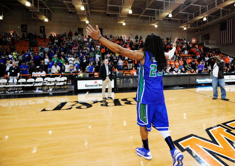 Florida Gulf Coasts Sherwood Brown (25) celebrates in front of the fans in the stands after his team defeated Mercer in an NCAA college basketball game for the Atlantic Sun mens tournament championship, in Macon, Ga., Saturday, March 9, 2013. Florida Gulf Coast won 88-75. (AP Photo/Woody Marshall)