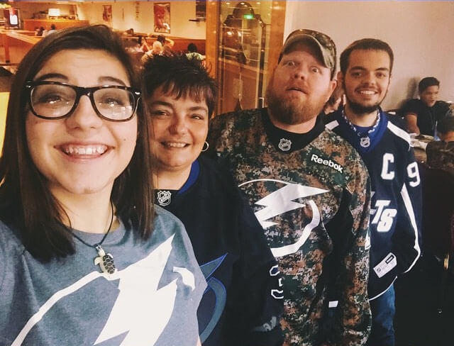 (Left) Nadia Anderson poses with her mother Cashawna Anderson (left center), a friend (right center) and her brother Austin Anderson (right) at a Tampa Bay Lightning hockey game. According to several of her friends, Anderson enjoyed singing, performing in theatre and watching movies like Star Wars and Disney’s Big Hero 6. Her friends remembered her caring nature and her general selflessness. (Photo courtesy of Nadia Anderson’s Facebook page)