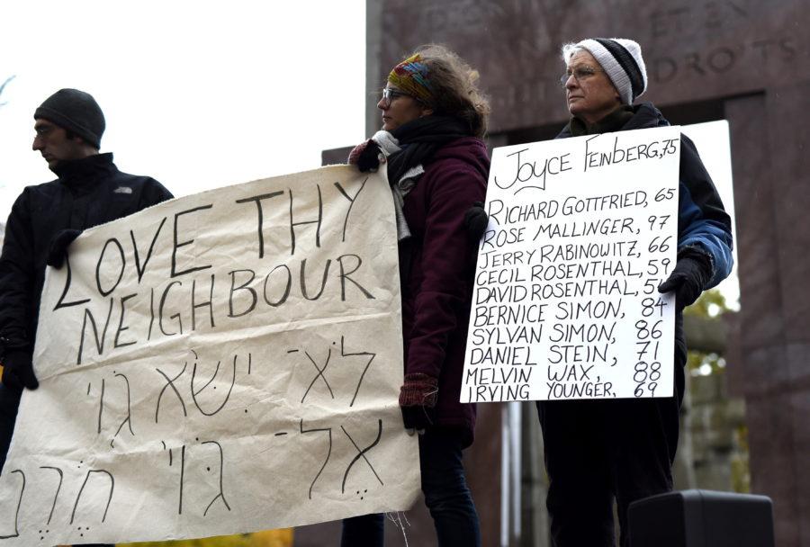 Names of the victims in Saturdays deadly shooting at the Tree of Life Synagogue in Pittsburgh are held during a vigil against anti-Semitism and white supremacy at the Human Rights Monument in Ottawa, Ontario, Sunday, Oct. 28, 2018. (Justin Tang/The Canadian Press via AP)