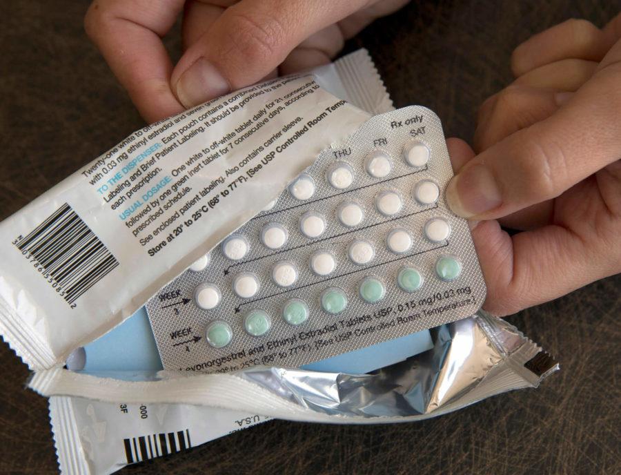 FILE - In this Aug. 26, 2016, file photo, a one-month dosage of hormonal birth control pills is displayed in Sacramento, Calif. Millions of American women are receiving birth control at no cost to them through workplace health plans, the result of the Obama-era Affordable Care Act, which expanded access to contraception. (AP Photo/Rich Pedroncelli, File)