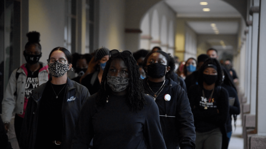 Students march past Reed Hall in student protest