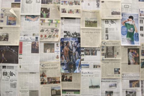 Years of Eagle News issues cover a wall in the University Archives exhibit Wings Up: 25 Years of Student Life at FGCU.
