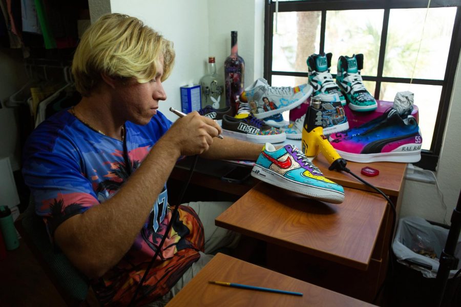 Lamanna works on a commissioned pair of custom shoes in his North Lake Village dorm room.
