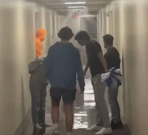 Dorm residents enter the hallway and see the burst water pipe as it begins to flood the hallway. Photo courtesy of Jack Gerrish.