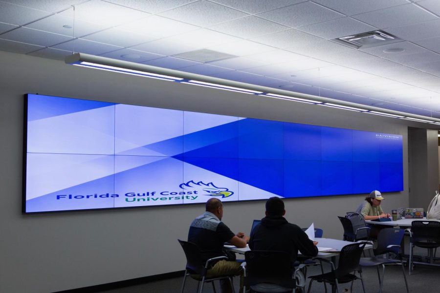 When the data visualization isnt being used, FGCUs new logo is displayed along with the programs software, Haivisions Video Wall Software.