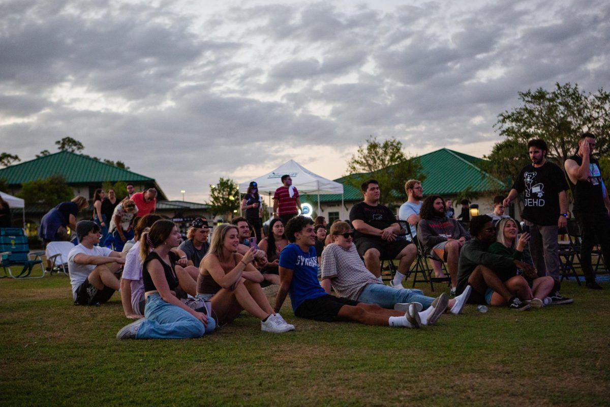 Students sit on the Library Lawn and watch performances at the 2023 Eagle Radio Music Festival. 